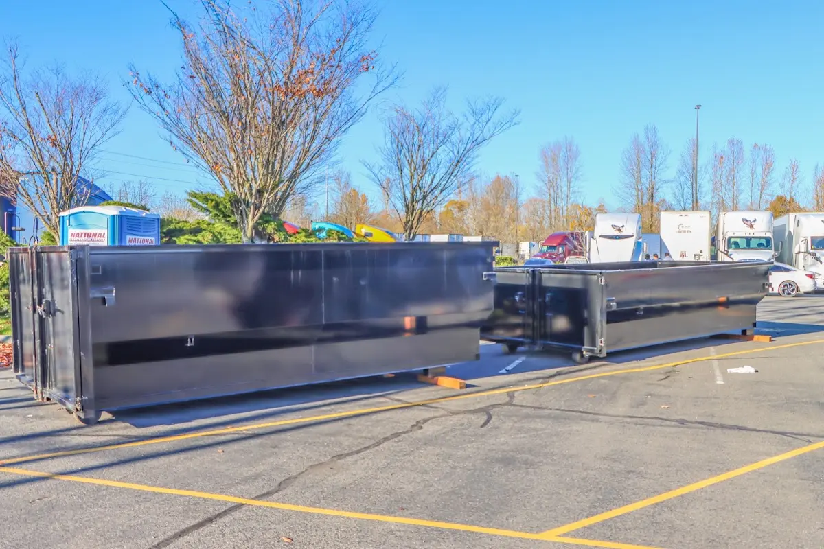 Professional dumpster rental service with roll-off container on residential driveway in Sturgeon Bay